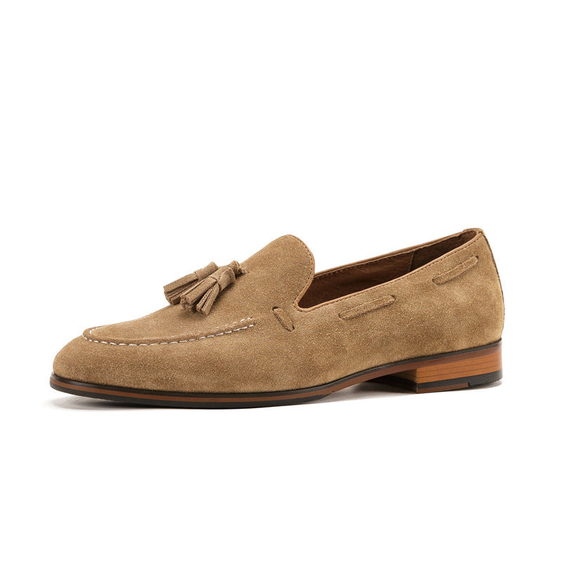 Tan suede loafer with a tassel on a white background