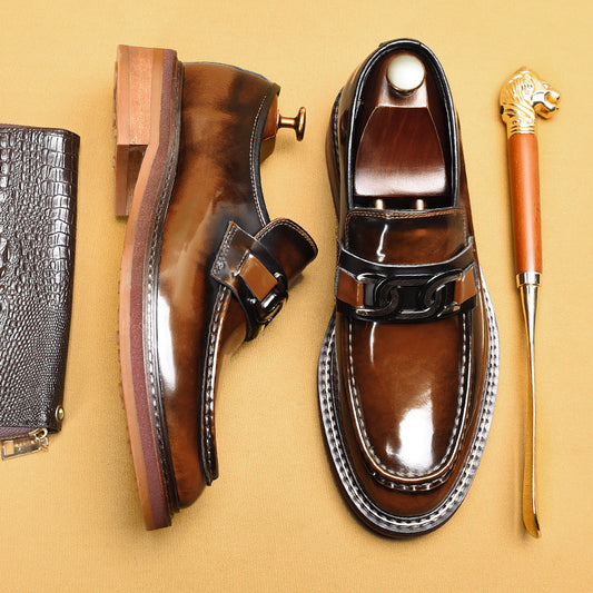 Brown leather shoes with a buckle on a beige background